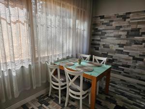 a dining room with a table and white chairs at Grey central apartment in Varna City +14 photos