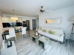 塔里法的住宿－Apartamento Musa Tarifa，一间带白色沙发的客厅和一间厨房