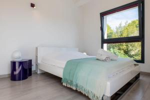 a bedroom with a bed and a large window at Vacation villa swimming pool and pétanque court ! in Biot