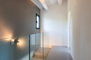 un escalier dans une maison avec une balustrade en verre dans l'établissement Vacation villa swimming pool and pétanque court !, à Biot