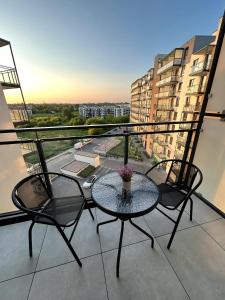 a table and chairs on a balcony with a view at L11 Warsaw Apartments in Warsaw