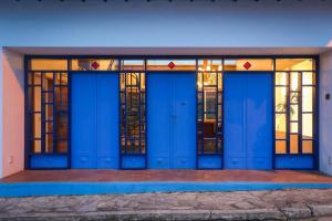 a row of blue doors with stained glass windows at Hotel Porto do Ribeirão in Iporanga