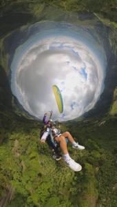 a person riding a parachute in a cave at Granja Don Fabio in Lemos