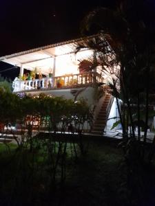 a white house with stairs in the night at Granja Don Fabio in Lemos