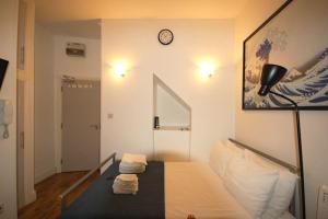 a room with a bed and a clock on the wall at Corbyn Street Flat 2 in London