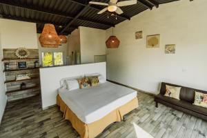 a bedroom with a bed and a couch at Ocean Paradise in Barra de Santiago +46 photos