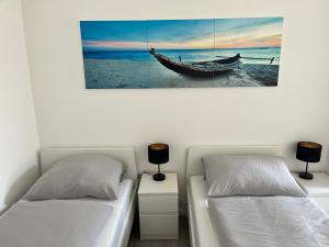 a bedroom with two beds and a boat on the wall at Nauheim-Residenz in Bad Nauheim