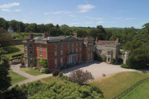 an aerial view of a large red brick house at Old Lodge Cottage, dog friendly and rural in Kempley