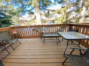 a wooden deck with chairs and a table at Lovely 3 bedrooms 2 bathrooms fourplex near Calgary Downtown in Calgary