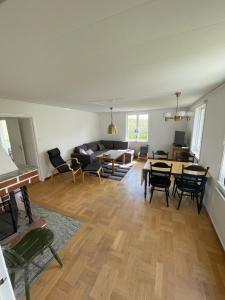 a living room with a couch and a table and chairs at Vänsö in Sankt Anna