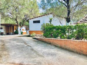 a house with a brick wall next to a street at Blu Med in Palinuro