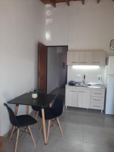 a kitchen with a table and chairs and a sink at Precioso departamento en Maipú in Maipú +5 photos