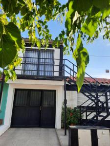 a building with black doors and a staircase at Precioso departamento en Maipú in Maipú
