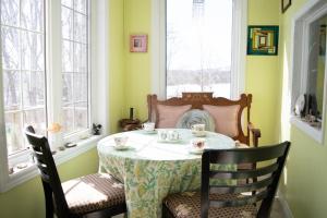 a table in a room with a table and two chairs at Rumi Guest House on the Cabot Trail in Indian Brook