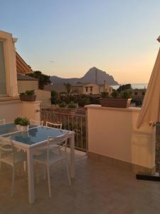 a patio with a table and chairs on a balcony at Casa Oltremare UnmarediBlu in San Vito lo Capo