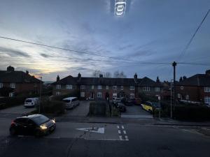 a street with cars parked in front of a building at Luxury Galaxy apartments in central Brentwood in Brentwood