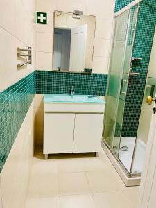 a bathroom with a sink and a shower at VILLAMOR in Albufeira