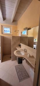 a bathroom with a sink and a mirror at Appartamento Virginia in Monti di Licciana Nardi