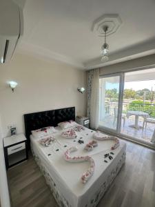 a bedroom with a large bed with flowers on it at Deniz Hotel in Finike