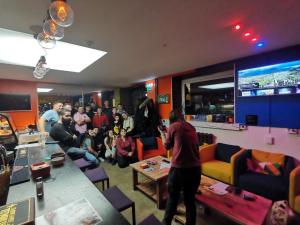 a group of people in a room with a crowd of people at Tiki Taka Hostel & Pub in Vilnius