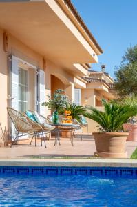 a villa with a swimming pool and a house at Villa Palmera in Palma de Mallorca