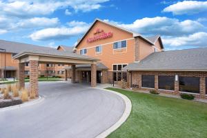 a hotel with a sign on the side of a road at AmericInn by Wyndham Green Bay East in Green Bay