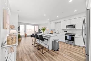 a large kitchen with white cabinets and black appliances at Exclusive property in the heart of marina del rey in Los Angeles