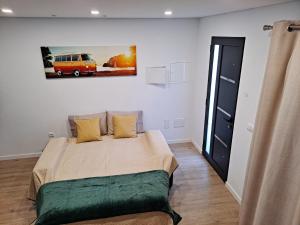 a bedroom with a bed and a painting on the wall at VCS House by Madeira Holiday in Funchal