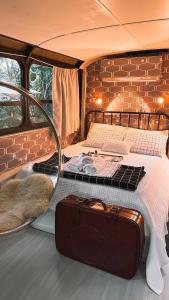 sypialnia z dwoma łóżkami i walizką w vanie w obiekcie Ônibus Retrô - Domingos Martins/ES w mieście Domingos Martins