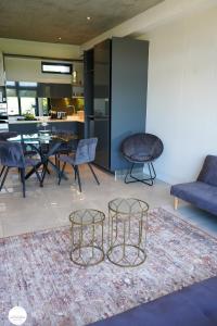 a living room with a dining table and chairs at OAM The Paramount Houghton in Johannesburg