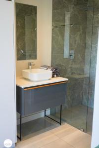 a bathroom with a sink and a shower at OAM The Paramount Houghton in Johannesburg