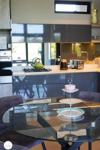 a kitchen with a glass table with a plate on it at OAM The Paramount Houghton in Johannesburg