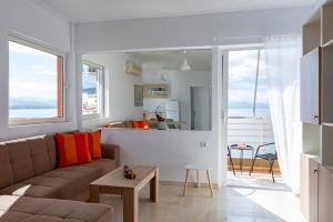a living room with a couch and a table at MC 2 Residences in Loutraki