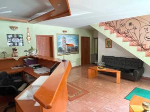 a living room with a couch and a staircase at Motel na vrchu Baba s.r.o. in Pezinok