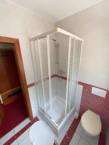 a shower stall in a bathroom with a toilet at Motel na vrchu Baba s.r.o. in Pezinok