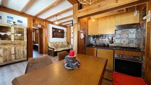 a kitchen with a table with a red candle on it at Hostdomus - Seguret in Cesana Torinese