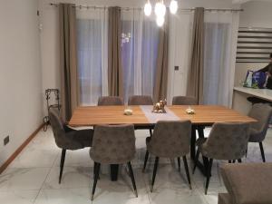 a dining room with a wooden table and chairs at Villa d’Ebene in Ebene