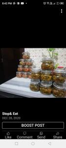 a display of jars of pickles on a table at Family House in Al Azraq ash Shamālī