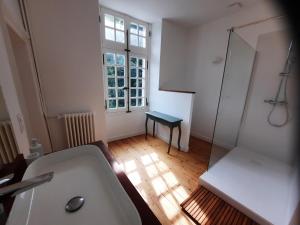 a bathroom with a sink and a toilet and a window at L'Essongère in Saint-Herblain