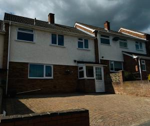 a house with a brick driveway in front of it at Luxury Jacuzzi Fast WIFI PS5 Gym Parking 2 spaces in Hereford