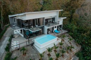 an aerial view of a house with a swimming pool at Vida Palace in Jacó