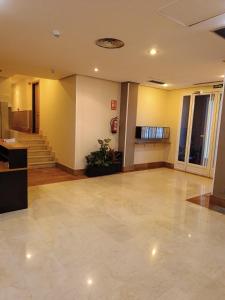 an empty lobby with a staircase in a building at Apartamentos GO Covaresa -Parking Gratuito in Valladolid