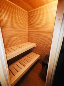 a wooden sauna with wooden shelves in a room at Ferienwohnung in Albstadt