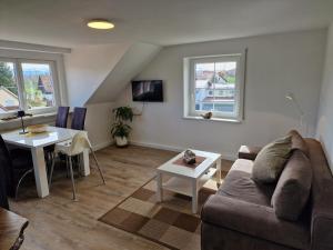 a living room with a couch and a table at Ferienwohnung Ingrid in Kressbronn am Bodensee