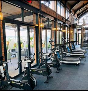 a row of tread machines in a gym at Outer Space - 1 bedroom Luxurious Apartment in Sandton in Sandown