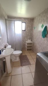 a bathroom with a toilet and a shower and a sink at Complejo De Cabañas Rukafill in San José de la Mariquina