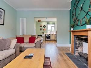 a living room with a large clock on the wall at 5* Fully furnished 5 bedroom service accommodation/holiday home - Sleeps up to 10 guests in Spinney Hill