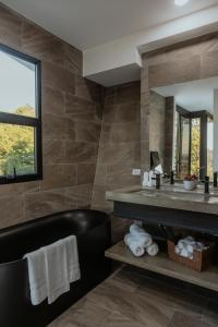 a bathroom with a sink and a mirror at Vida Palace in Jacó
