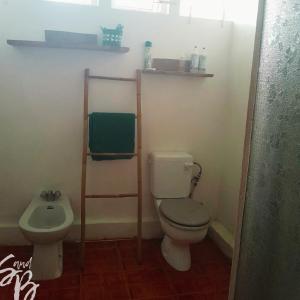 a bathroom with a toilet and a sink at Lakaz Metiss Arobaz in Blue Bay