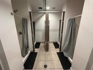 a bathroom with a walk in shower and a stall at House of Trestles in San Clemente